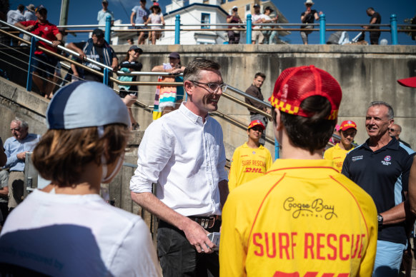 NSW Premier Dominic Perrottet speaks to volunteer surf lifesavers and Coogee nippers at Coogee Surf Life Saving Club on Wednesday.