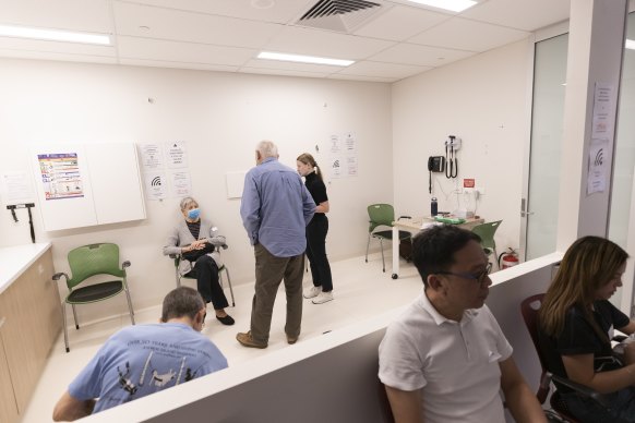 Patients sit in a waiting area after recieving the COVID-19 AstraZeneca vaccine at the Sydney West COVID vaccination centre in Olympic Park.