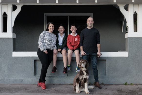 Neil and Jackie Blum with their children, Alfie and Charlie, and their dog Coco, outside their recently sold home in Mascot.