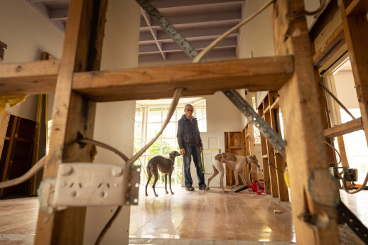 Janeann Fowkes in her Maribyrnong house. Flood-damaged sections of the walls have been removed.