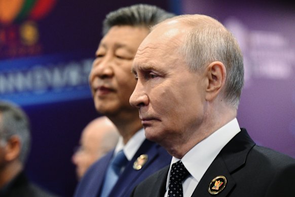 Putin stands alongside Chinese President Xi Jinping at the BRICS summit in India.
