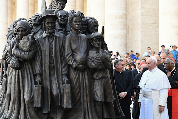 Pope Francis unveils a sculpture in St Peter's Square on the theme of refugees and migration.
