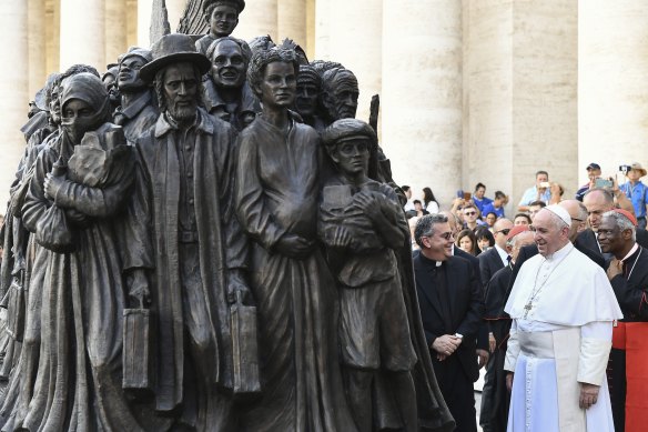 Pope Francis unveils a sculpture in St Peter's Square on the theme of refugees and migration.