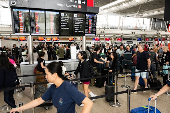 Passengers queue at Sydney Airport on Friday.