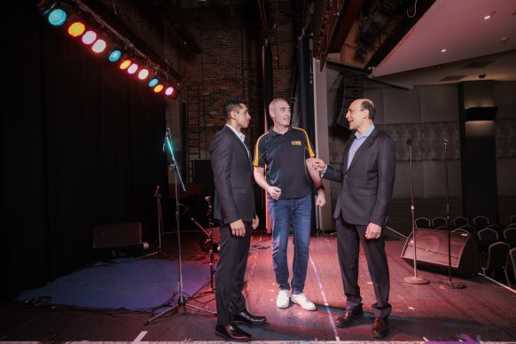 Greg Page with Pramesh and Joshua Kovoor on the stage at Castle Hill RSL where the former Wiggle suffered a cardiac arrest in January 2020. 