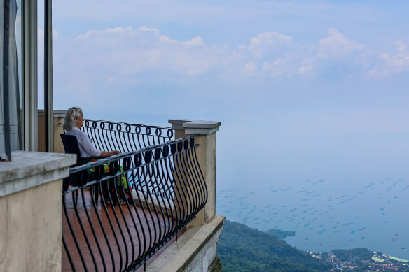 A tourist looks over Lake Taal from a room balcony at The Lake Hotel, in Tagaytay, Cavit.