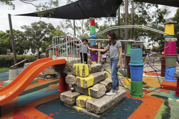 Louise Ives with her son at the playground on Friday morning.