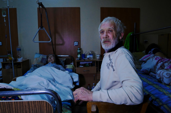 Vasyl, 65 (right), sits by his wife Ludmyla, 72 (left), whose left hand was amputated.