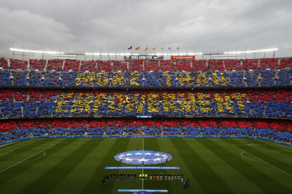 Supporters hold up banners at a packed Camp Nou.