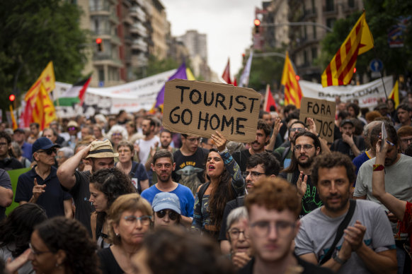 Demonstrators march shouting slogans against the Formula 1 Barcelona Fan Festival in downtown Barcelona, Spain, in June.