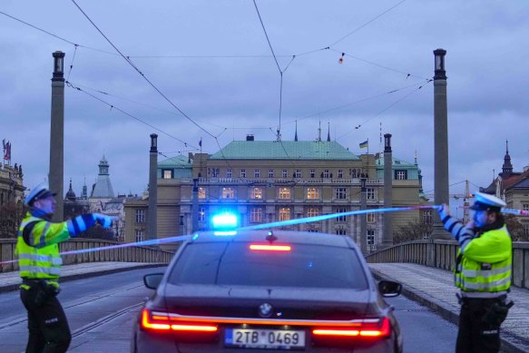 Officers guard a street in downtown Prague, Czech police say a shooting in downtown Prague has killed an unspecified number of people and wounded others.