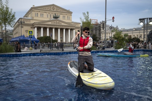 Meanwhile, in Moscow: A man rows an inflatable canoe in a makeshift pool in a street with the Bolshoi Theatre in the background during celebration of the Moscow City Day, celebrating the 875th anniversary of the city’s founding. 