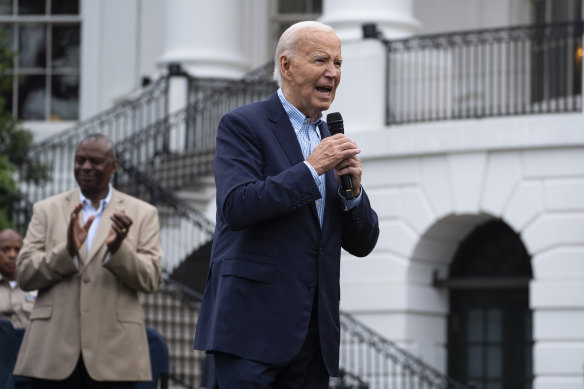 President Joe Biden speaks during a barbecue with active-duty military service members and their families on the South Lawn of the White House.