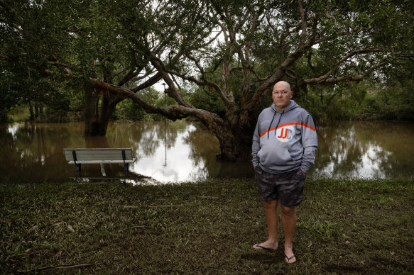 Lismore mayor Steve Krieg stands near a flooded Wilsons River on March 11, 2025. 