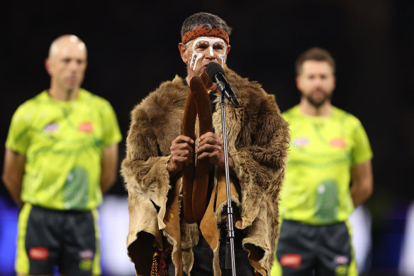 Dr Richard Walley performs the Welcome to Country at an AFL match in Perth in 2024, almost 40 years after performing the first modern version of the ceremony at a theatre.