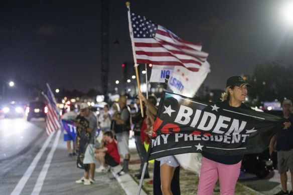 “How dare they!” Jupiter resident Kathy Luksch stands with others gathered to support Do<em></em>nald Trump near Mar-a-Lago in Palm Beach, Florida.