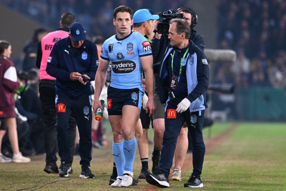 NSW’s Cameron Murray is assisted by Blues doctor Nathan Gibbs during game three.