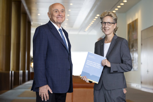 Professor Allan Fels hands over the report into Price Gouging and Unfair Pricing Practices to ACTU Secretary Sally McManus, at Parliament House in Canberra on Tuesday.