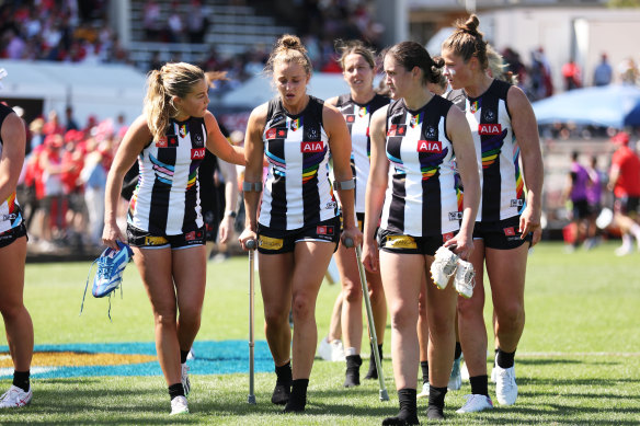 Collingwood’s Ruby Schleicher is consoled by teammates after coming off injured after the AFLW match against Sydney. 