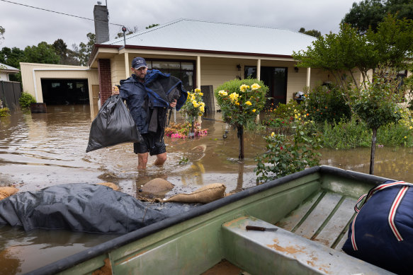 A resident flees the rising floodwaters in Echuca, Victoria, last month. Floods have proved costly for insurers this year.