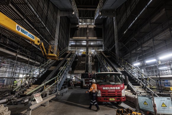 Commuters will use escalators to descend a giant atrium in the Martin Place metro station when it opens next year.