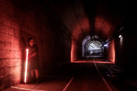 Production assistant Victoria Lewis at work in the old Wynyard tunnels, which are being opened to the public for Vivid.