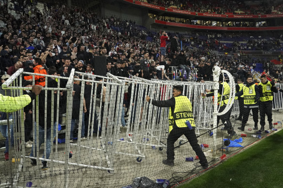 Lyon fans attempt to enter the field of play after full-time.