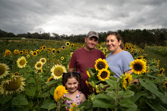 Marika and John Saliba with their daughter Roxanne at their flower farm.