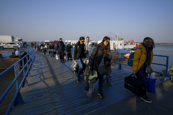 Refugees flee by ferry at the Isaccea-Orlivka border crossing.