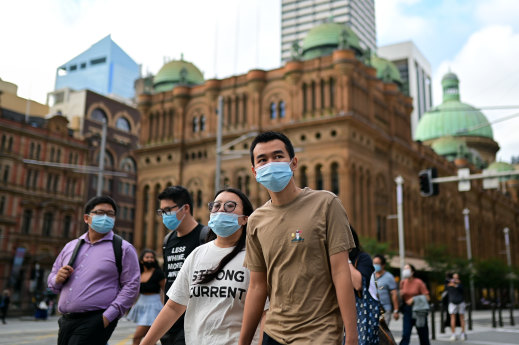 Pedestrians wearing face masks in Sydney's CBD on Thursday.