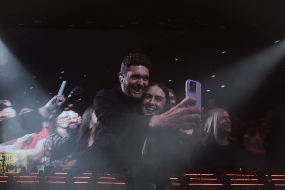 Buble takes a selfie with a fan at his Sydney show.