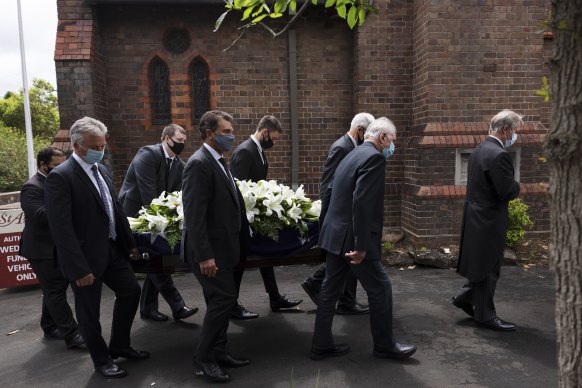 Pallbearers including former Australian captains Steve Waugh, Ian Chappell and Mark Taylor carry the coffin of Alan Davidson on Monday.