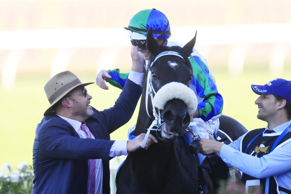 Trainer Peter Moody greets Luke Nolen as he returns on  I Wish I Win after winning the Golden Eagle.