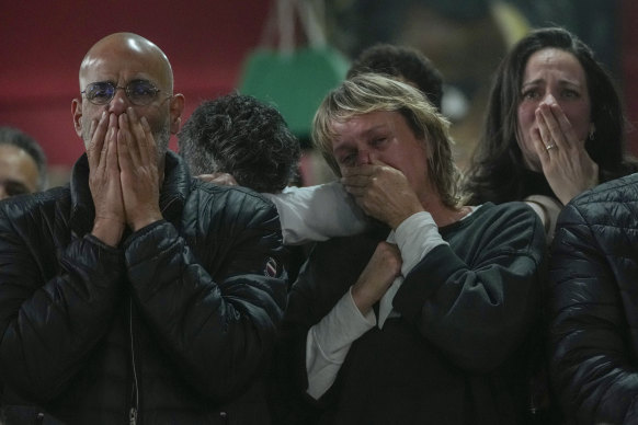 Friends and relatives of Ohad Ben Ami and Eli Sharabi, who were taken as hostages by Hamas on October 7, 2023, react as they watch the live broadcast of their release from Gaza.