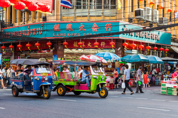 Colourful transport in spades … Tuk-tuks weave through Bangkok’s Chinatown.