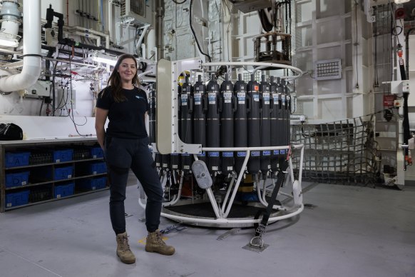 Margot Hines, the voyage manager, with the CTD which can plunge 5000 metres beneath the waves and collects “snapshot” samples of the deep ocean. Piecing the data together will reveal more about the depth and movement of eddies.