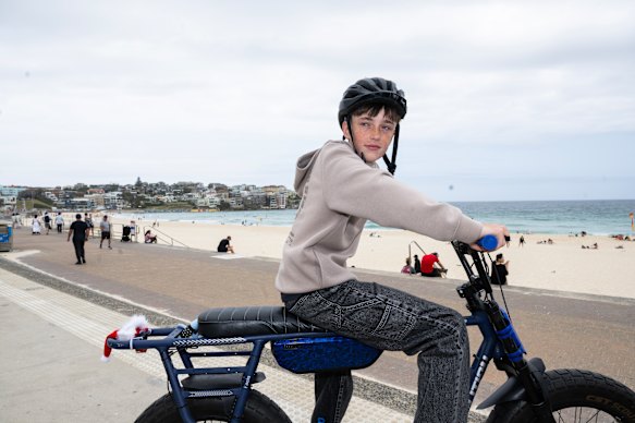 Ryan Angler, 14, rides his bike at Bondi Beach after the social media ban began.
