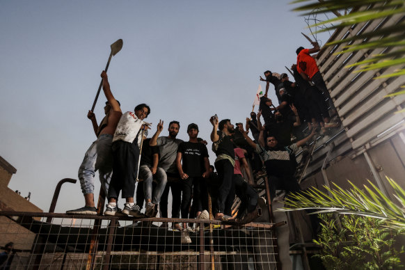 Protesters near the Swedish embassy in Baghdad hours after the embassy was stormed and set on fire.