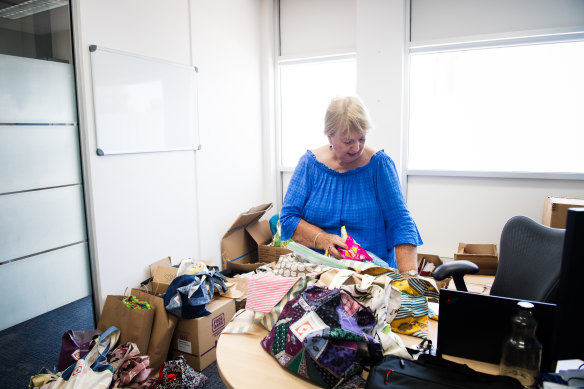 Gray puts together care packages in the Red Cross office in Ballina. 