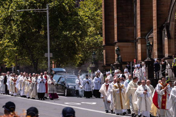 The coffin carrying Cardinal George Pell leaves the cathedral.