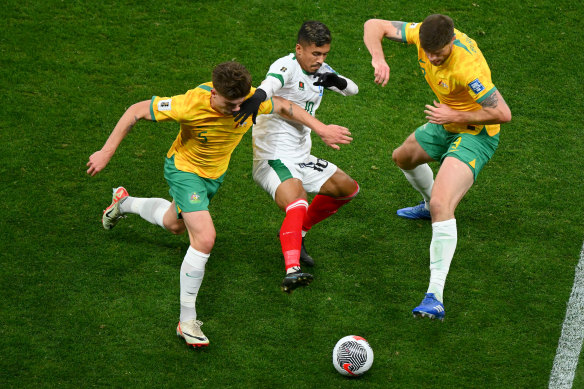 Jordan Bos and Cameron Burgess of the Socceroos defend against Rakib Hossain of Bangladesh