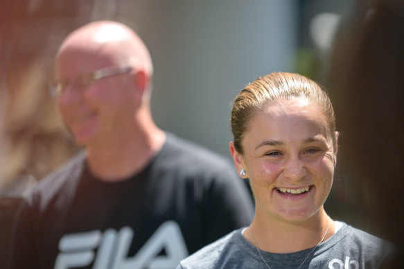 Ash Barty, with coach Craig Tyzzer in the background, speaks to the media in Brisbane on Thursday.