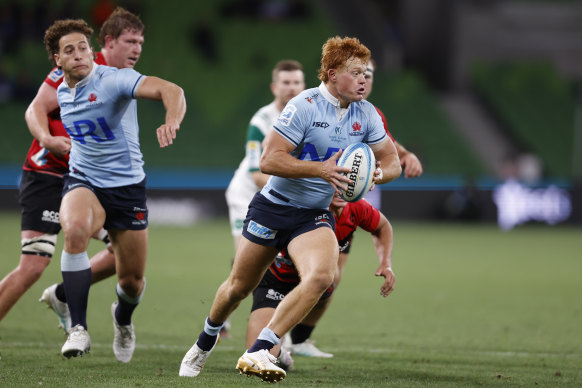 Tane Edmed of the Waratahs runs with the ball during Super Round against the Crusaders in Melbourne 
