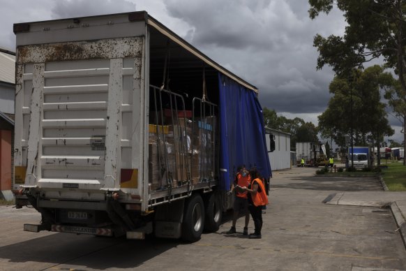 Trucks of COVID supplies are loaded for distribution.