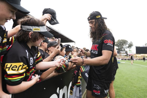 Luai signs autographs after training on Tuesday.