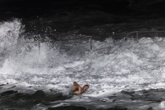 A swimmer at Bronte ocean pool on Thursday morning as heavy surf begins to impact the Sydney coast.