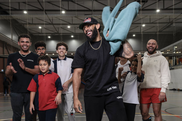 Josh Addo-Carr with community members at the Redfern centre.