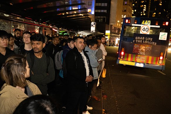 Commuters outside Central train station waiting for buses following a power failure at Strathfield. 