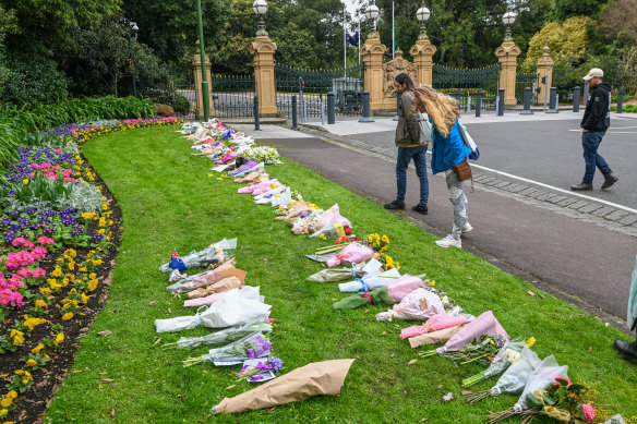 Mourners leave floral tributes to the Queen outside Government House. 