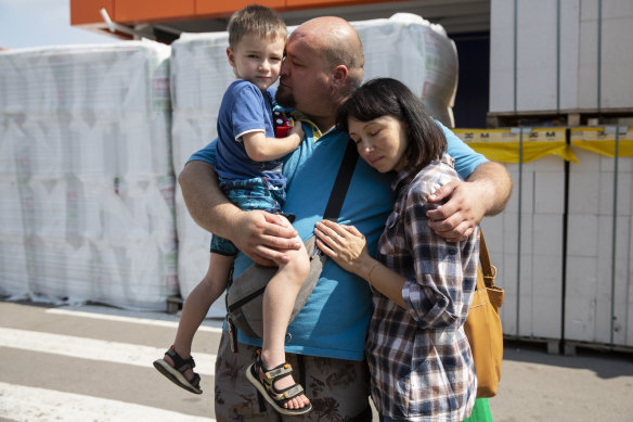Olexander Soroka weeps as he hugs his wife and son before they leave on an evacuation bus at a humanitarian aid centre for internally displaced people in Zaporizhzhia, Ukraine.  